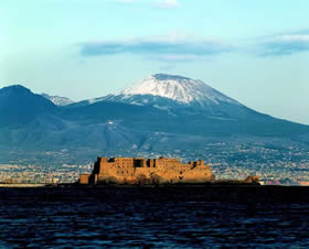 Castel dell'Ovo, a Norman masterwork, with an unusually snow-capped Vesuvius in the background - Credit - De Agostini Picture Library
